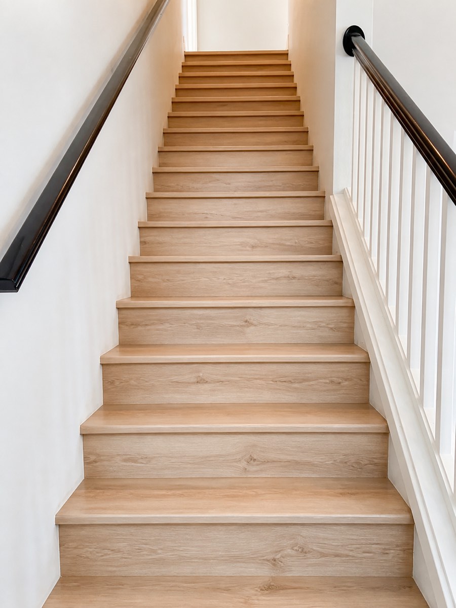 Staircase with custom light oak treads and white risers